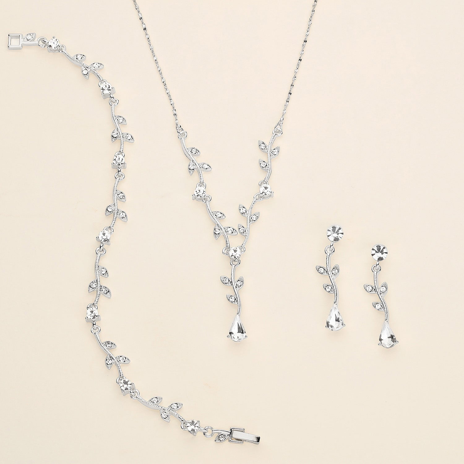 a necklace and earring set is shown on a white surface