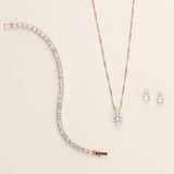 a necklace, earrings, and bracelet on a white surface