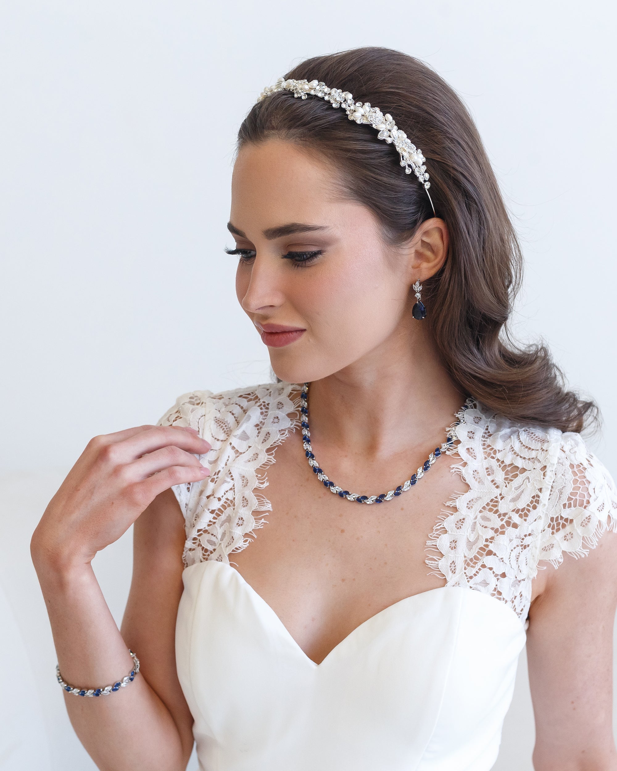 a woman wearing a white dress and a necklace