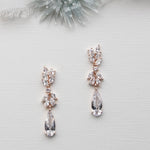 a pair of earrings sitting on top of a white surface