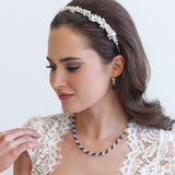 a woman in a white dress wearing a headband