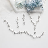 a necklace and earrings on a white cloth