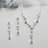 a necklace and earring set with a flower