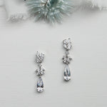 a pair of earrings sitting on top of a table