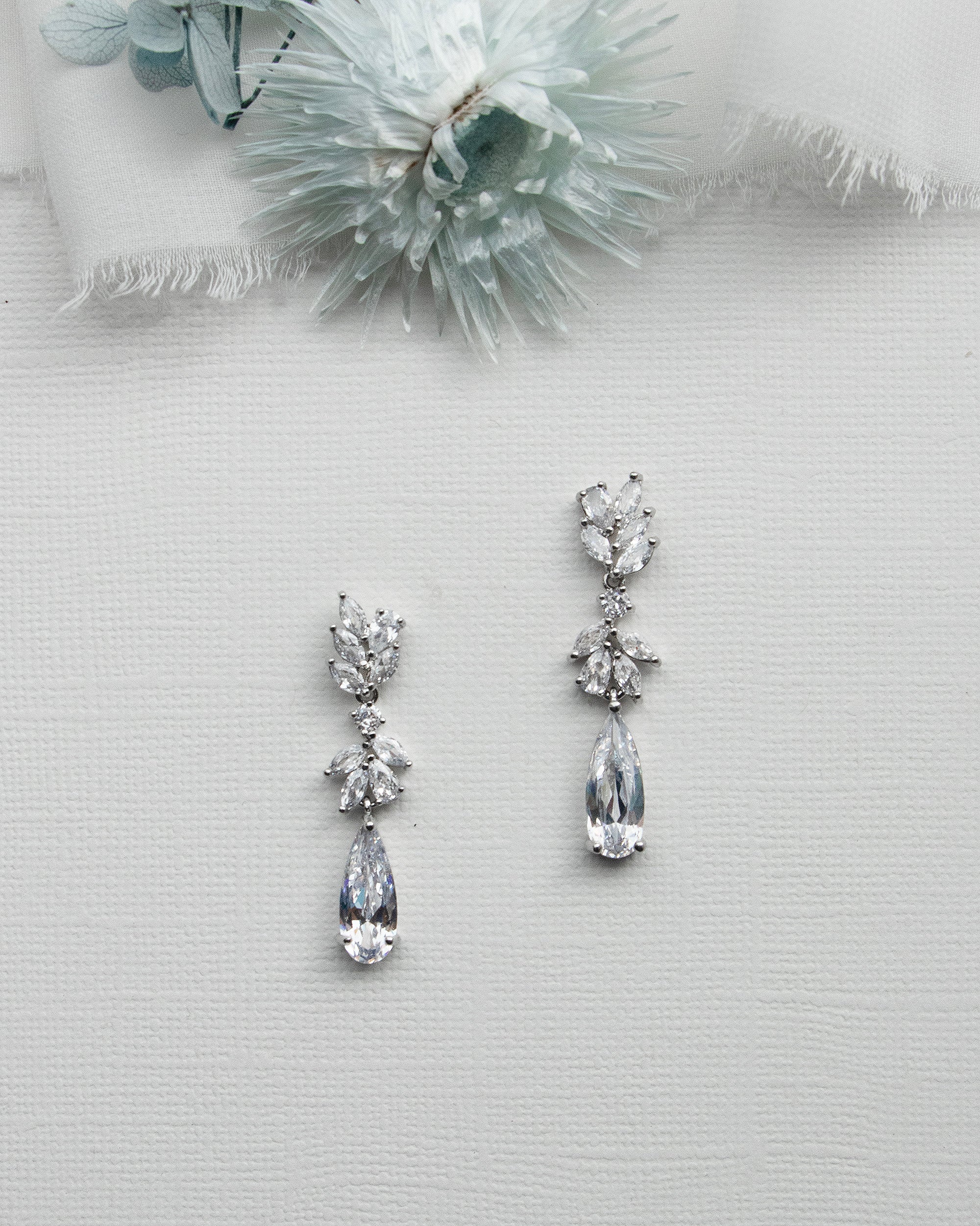 a pair of earrings sitting on top of a table
