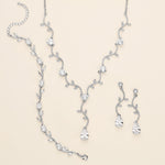 a necklace and earring set with a diamond