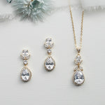 three pieces of jewelry on a white surface