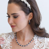a woman wearing a necklace and a headband