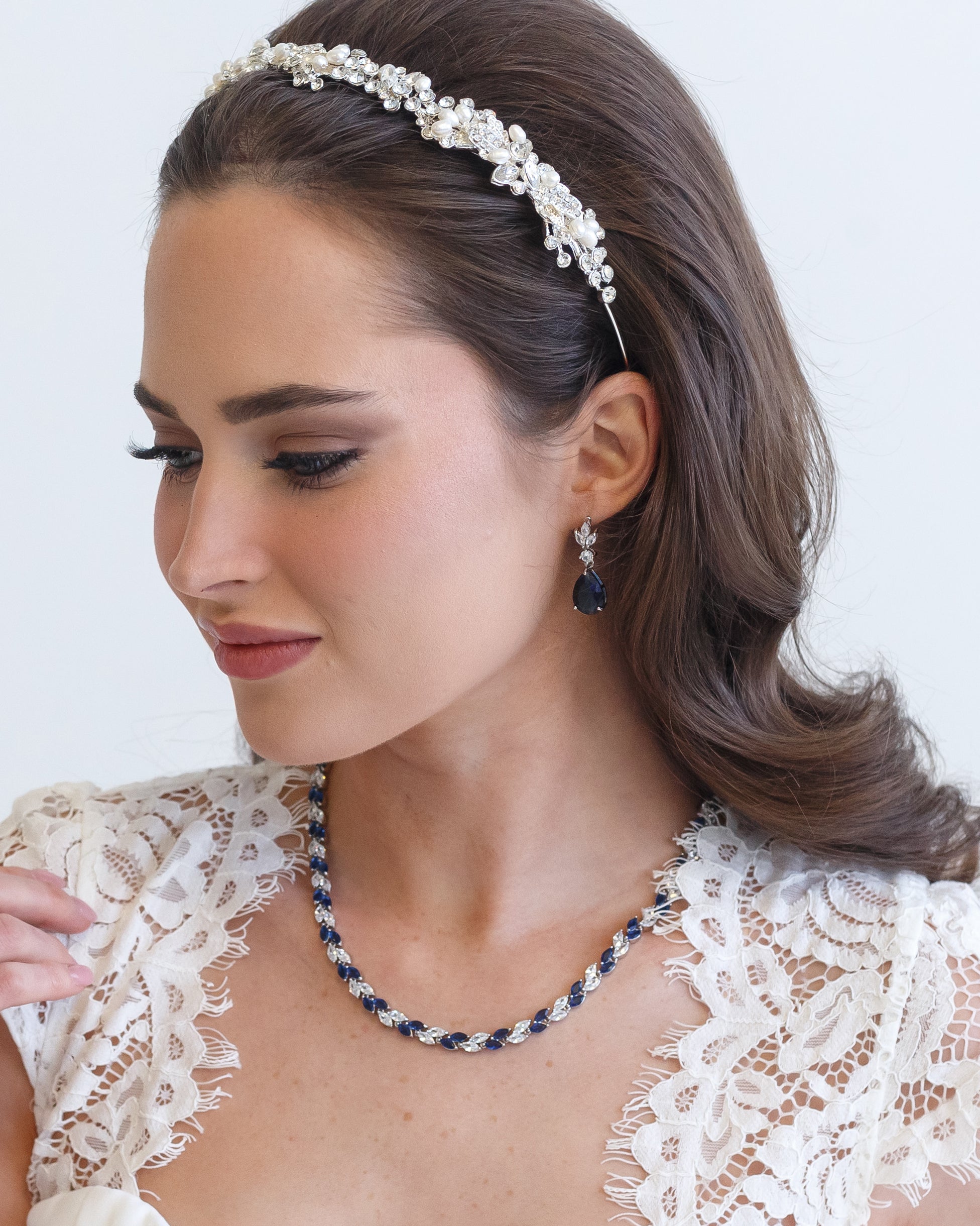 a woman wearing a necklace and a headband