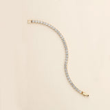 a gold and diamond bracelet on a white background