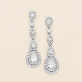 a pair of diamond earrings on a white background