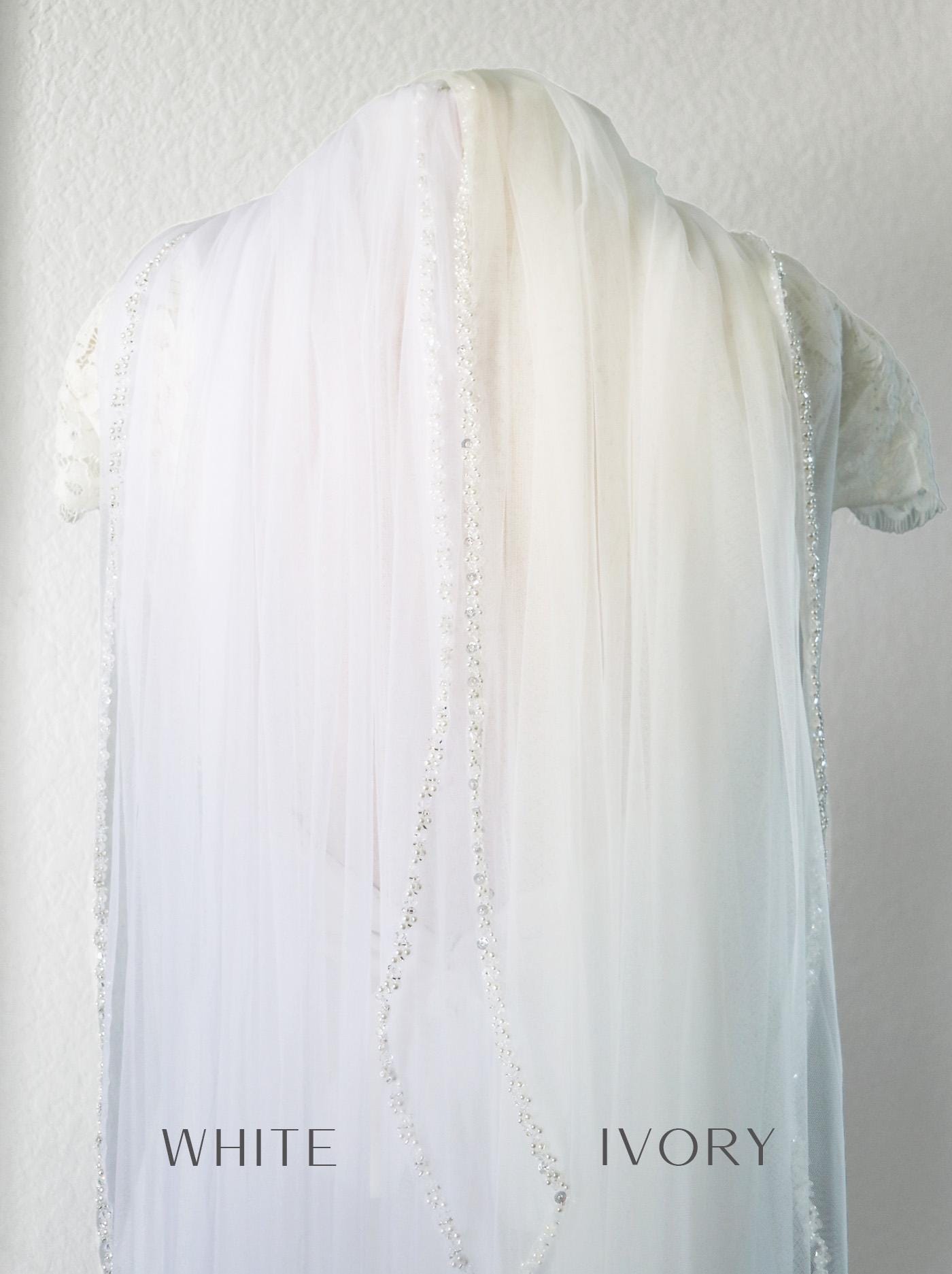 the back of a white shirt with pearls on it