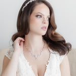 a woman in a white dress wearing a tiara