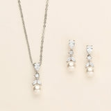 a necklace and earring set with pearls
