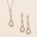 a pair of earrings and a necklace on a white background