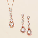 a pair of earrings and a necklace on a white background