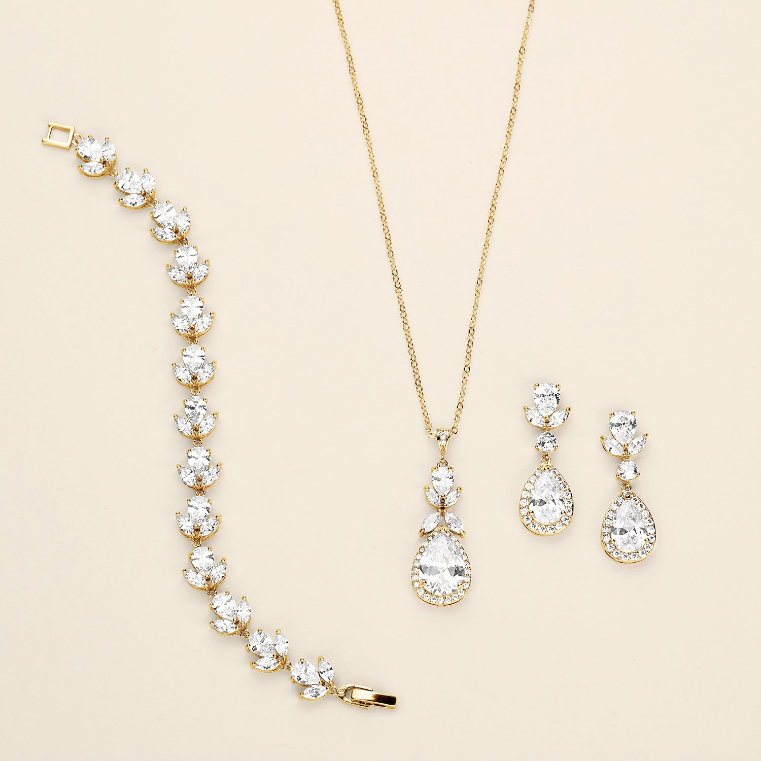 a necklace, bracelet, and earrings are shown on a white surface