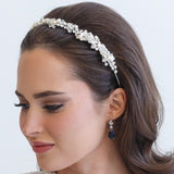 a woman wearing a headband with pearls on it
