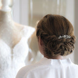 a woman is looking at a dress on a mannequin