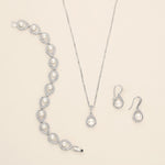 a necklace, bracelet, and earrings are shown on a white surface