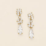 a pair of gold tone earrings with clear stones