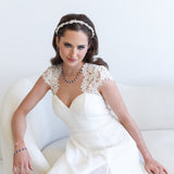 a woman in a white dress sitting on a white couch