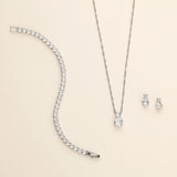 a necklace, earrings, and bracelet on a white surface