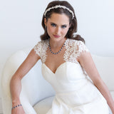 a woman in a white dress sitting on a white couch