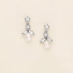a pair of white pearl and crystal earrings
