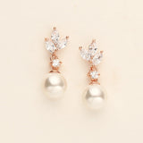 a pair of pearl and diamond earrings