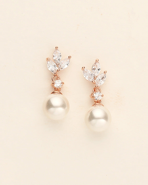 a pair of pearl and diamond earrings