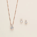 a necklace and earring set on a white surface