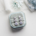 a pair of earrings sitting on top of a white table