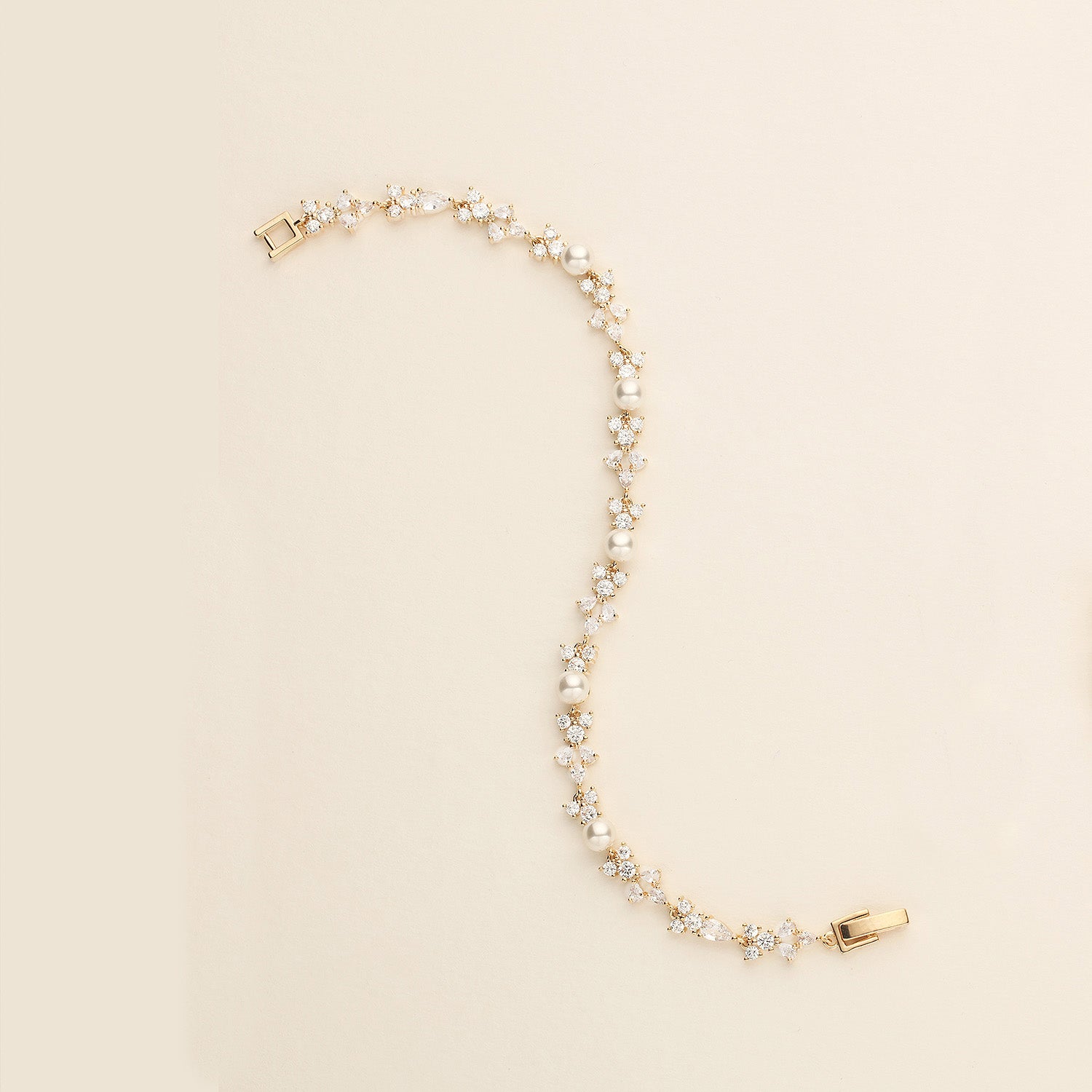 a pearl and gold necklace with a watch on it