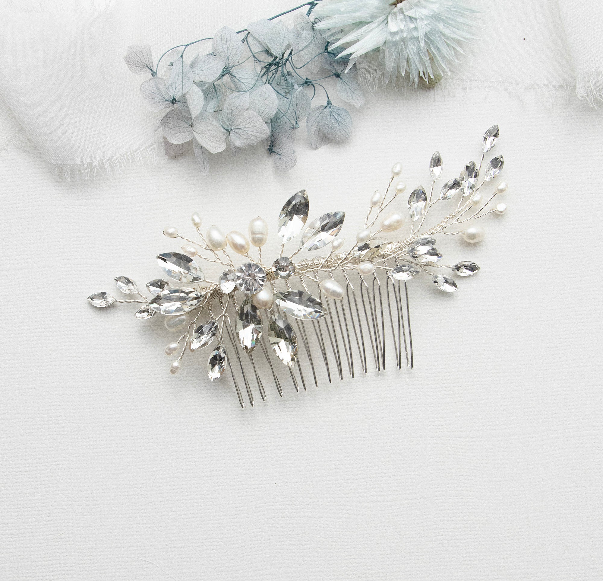 a close up of a hair comb with flowers in the background