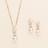 a necklace and earring set with pearls