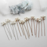a set of five hair pins with pearls