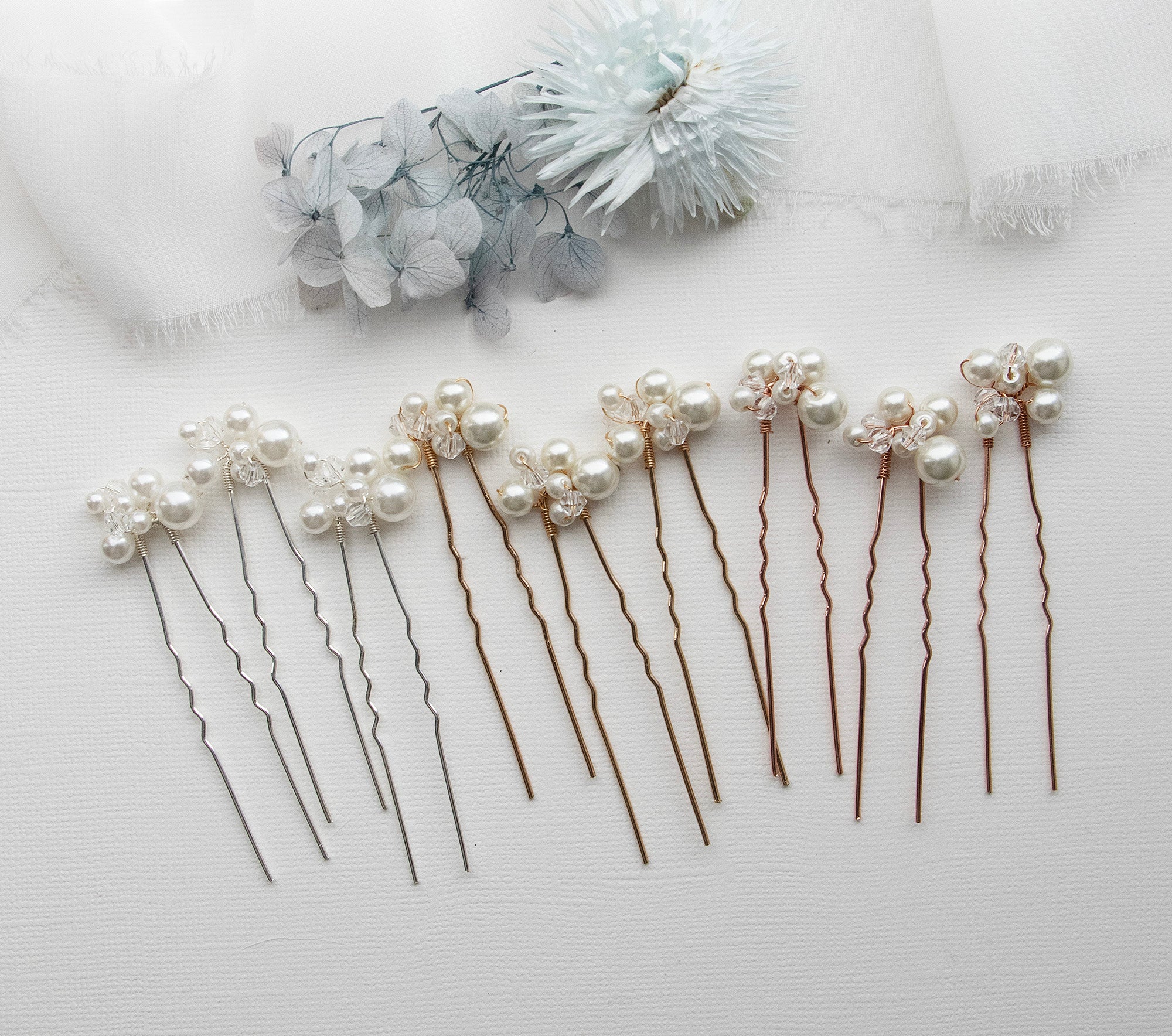 a set of five hair pins with pearls