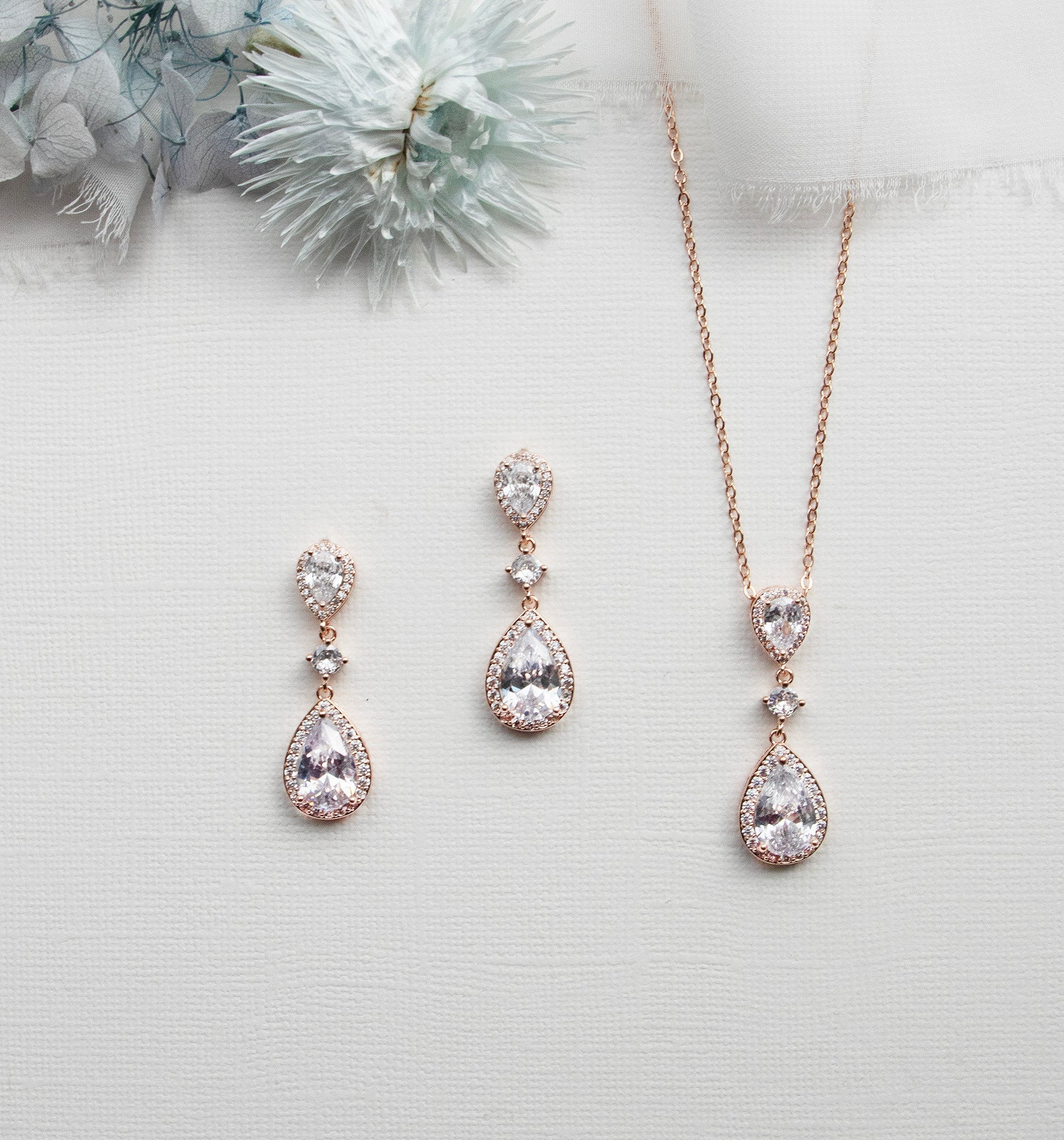 a necklace, earrings, and ring sitting on a table