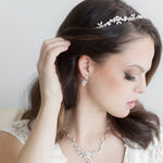 a woman wearing a tiara and a necklace