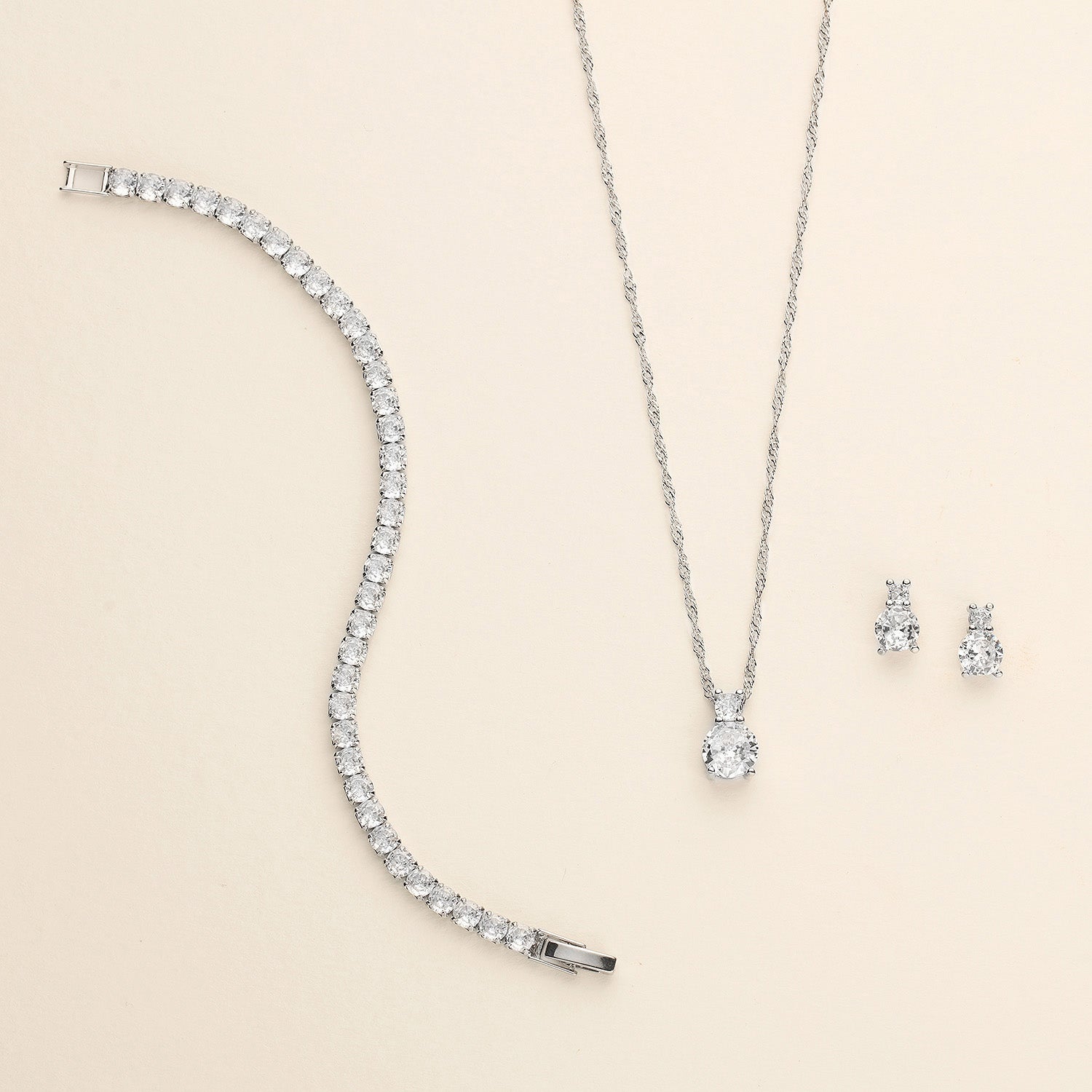 a diamond necklace and earring set on a white background