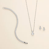 a diamond necklace and earring set on a white background