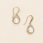 a pair of earrings with a pearl and diamond drop