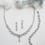 a necklace and earring set with a bouquet of flowers