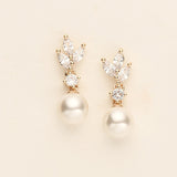 a pair of pearl and diamond earrings