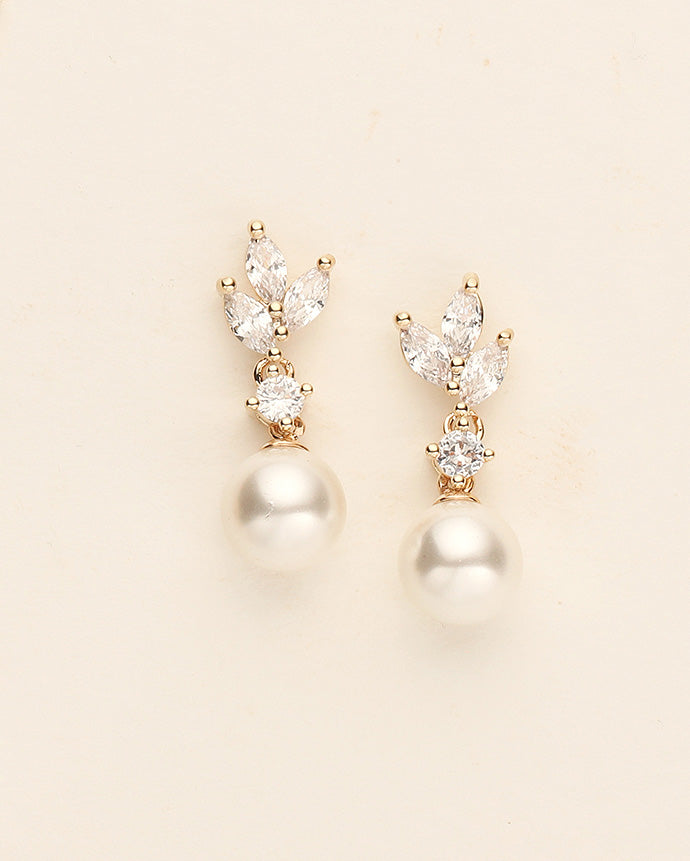 a pair of pearl and diamond earrings