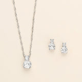 a pair of earrings and a necklace on a white background
