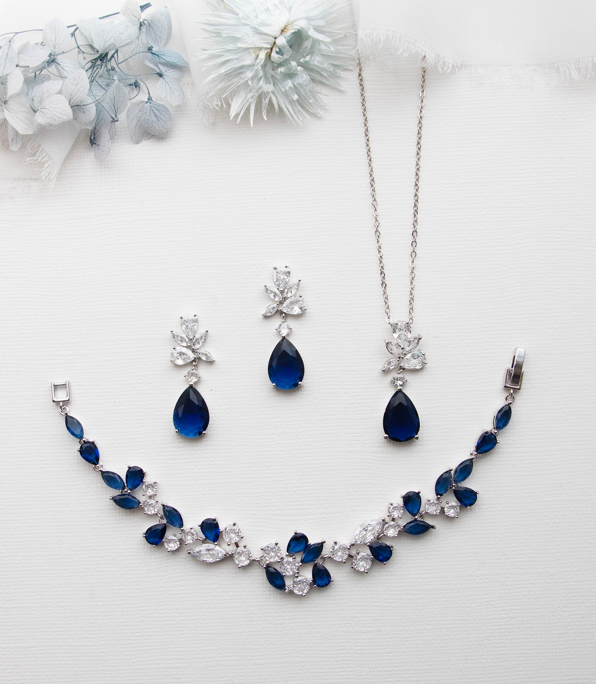 a necklace and earring set with blue stones