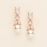 a pair of diamond and pearl earrings