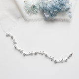 a silver chain with a flower on it